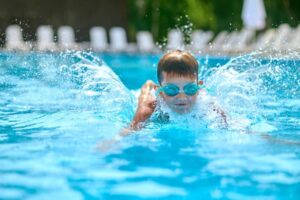 Kid swimming and playing in a pool