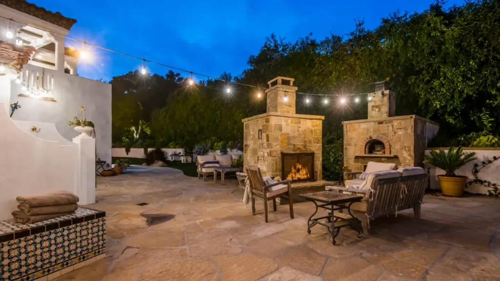 Custom outdoor fireplace in a landscaped backyard