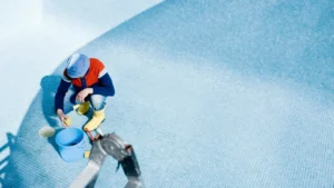 worker cleaning pool tiles