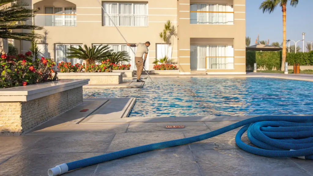 man cleaning a residential pool
