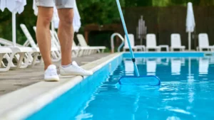pool technician cleaning the swimming pool